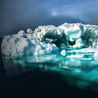 A large piece of ice floating on top of the water.